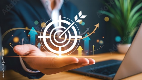 Businessman holding target board with arrow for business achievement goal
