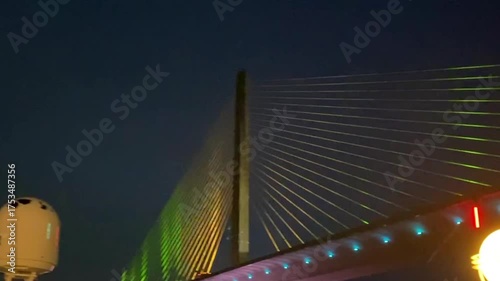 Tampa, Florida: Norwegian Jade cruise ship sailing under the Sunshine Skyway Bridge in Tampa Bay at night.