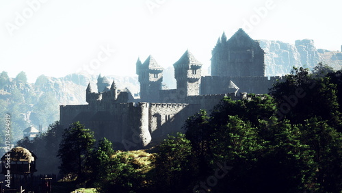 Fotografie A grand castle stands tall on a hillside, surrounded by lush greenery