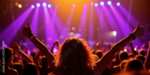 a crowd at a concert with their hands up
