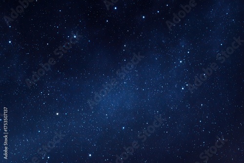 Fototapeta Naklejka Na Ścianę i Meble -  A dark blue celestial expanse filled with thousands of twinkling stars, evoking the vastness of space