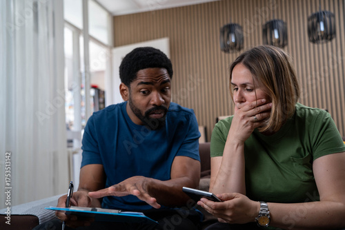 Quadro su tela Mixed race couple stressed about household finances, rising food and housing cos