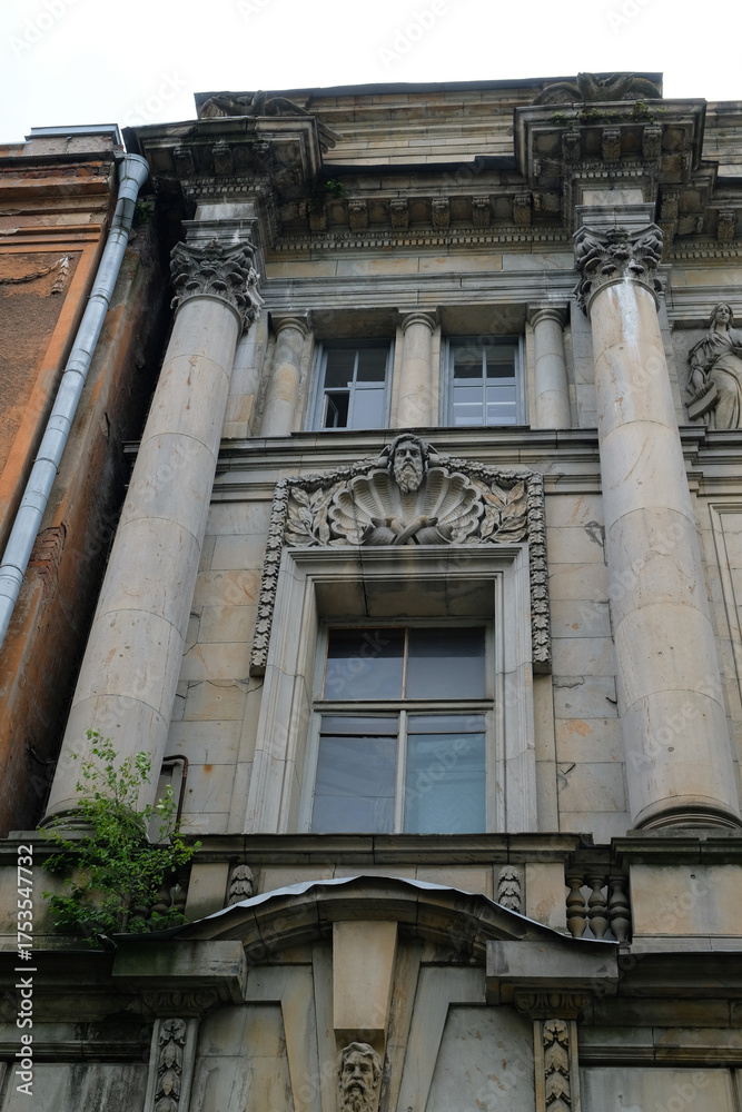 Fototapeta premium the facade of a building with columns and bas-reliefs above the window