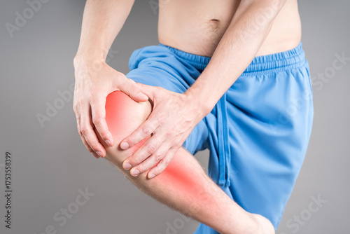 Wallpaper Mural Knee pain, joint inflammation, arthritis and degenerative changes, man suffering from leg ache and doing self-massage on gray background Torontodigital.ca