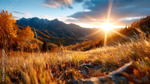A stunning view of a rugged mountain range at sunset, showcasing vibrant autumn colors and dramatic lighting, perfect for capturing the beauty of nature's transitions.
