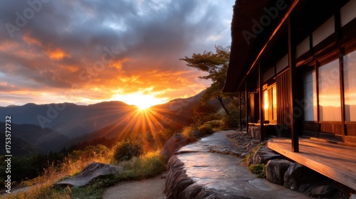 A breathtaking sunset illuminating a traditional Japanese house set amidst towering mountains, embodying the tranquility and beauty of nature's paintbrush at dusk.