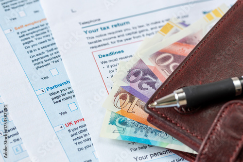  United Kingdom tax settlement. Tax forms. UK money wallet. Financial business concept. Filling out a form. Close up