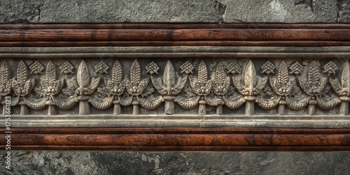 Ornate Stone Frieze with Intricate Botanical Relief Carving, Framed by Smooth Dark Wood Borders on a Textured Wall