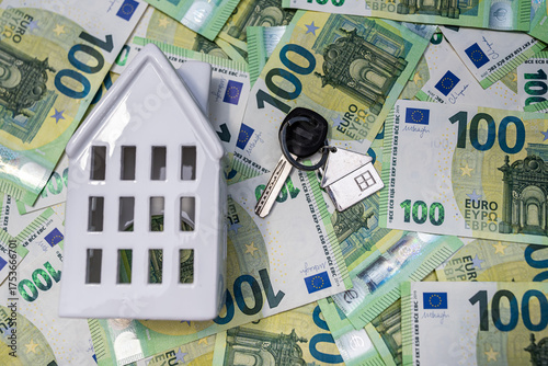 Euro bills with keychain house representing real estate savings, wealth and home ownership success.
