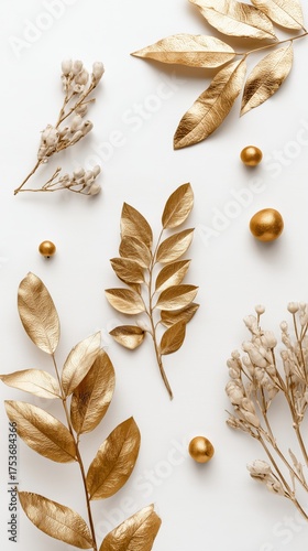 Elegant Golden Leaves and Flowers Arranged on a White Background for Artistic...