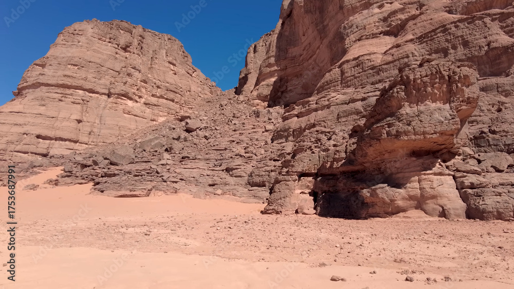 Fototapeta premium A trip to Sahara desert in Algeria. Beautiful african travel photo. Sandy landscapes, mountains, rocks, dunes, and nature. Summer vacation in arab country.
