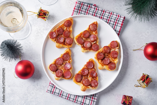 Pizza mini with salami in the form of Christmas trees for Christmas holidays