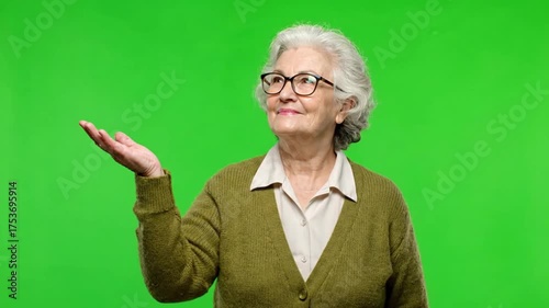 Elderly Woman with Glasses Presenting on Green Screen.