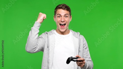 Excited Young Man Celebrates Video Game Victory on Green Screen.