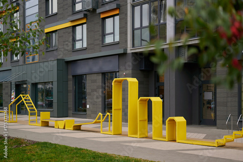 yellow outdoor structure in vibrant urban setting, modern architecture background, creative design inviting exploration. perfect for cityscape-themed projects, playful architectural studies