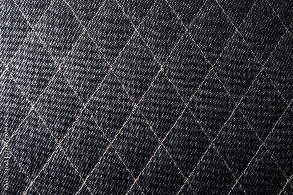 Naklejka premium Close-Up of Quilted Dark Fabric with Diamond Stitch Pattern