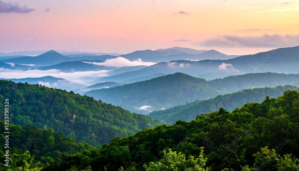 Fototapeta premium A scenic view of layered mountain ranges fading into the horizon, kissed by a pastel sunset with clouds nestled in the valleys
