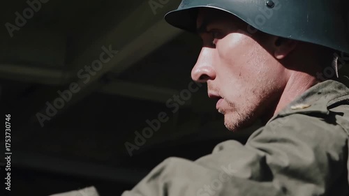 Soldier in Helmet Looking Down Thoughtfully (seamless loop)