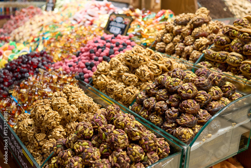 A vibrant array of colorful sweets and candies, beautifully arranged for sale. A feast for the eyes with delicious treats.