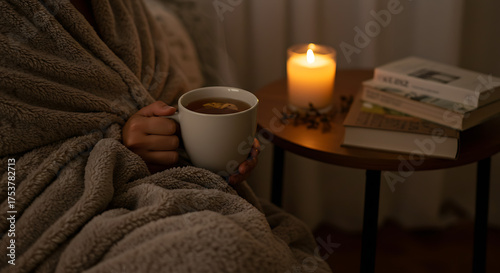 Night relaxation ritual scene with candlelight, tea, and soft blanket