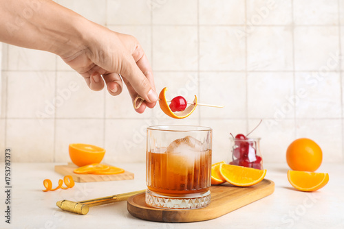 Hand garnishing old fashion...