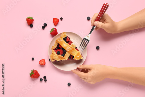 Woman eating tasty berry pi...