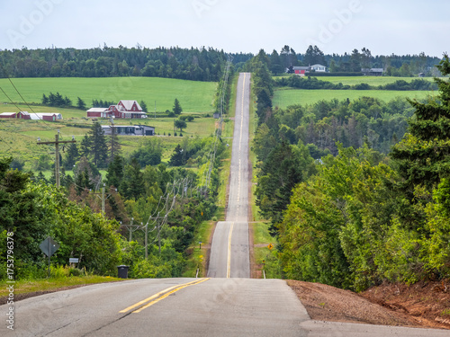 Straight road  in  hilly rural countyside on Prince Edward Island Canada