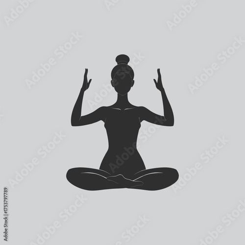 Silhouette of a woman meditating in a lotus position peacefully