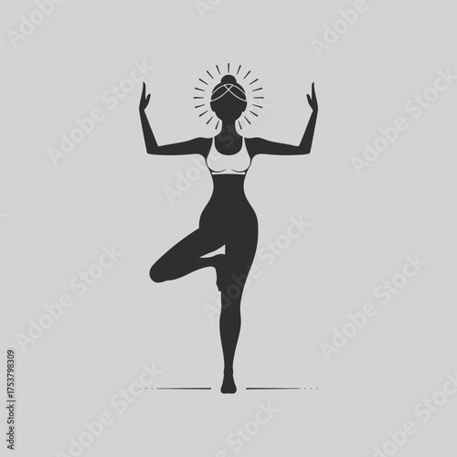 Silhouette of a woman practicing yoga in a balanced tree pose