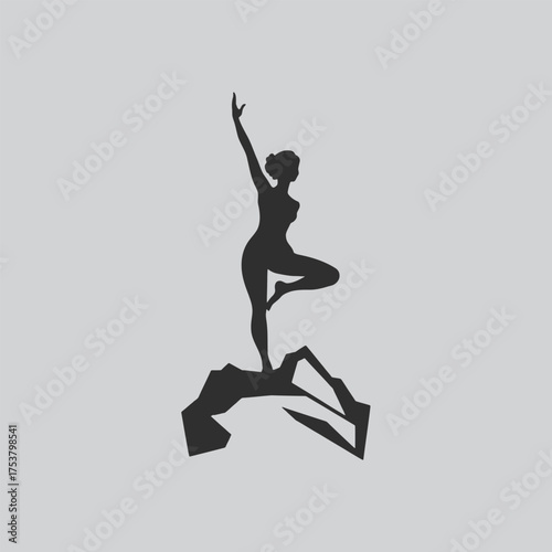 Silhouette of a woman practicing yoga on a mountainous peak