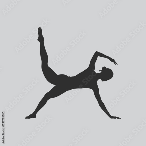 Silhouette of a woman in a dynamic ballet pose against a gray background