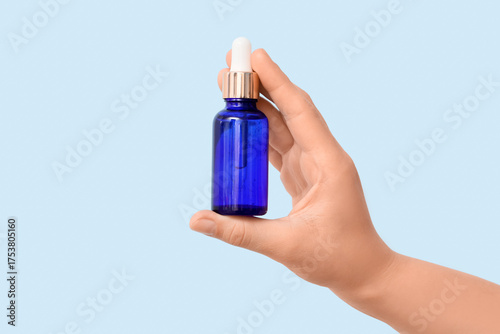 Female hand with bottle of ...