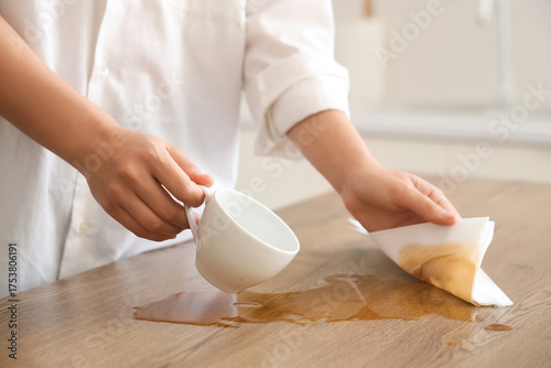Woman wiping spilled coffee...
