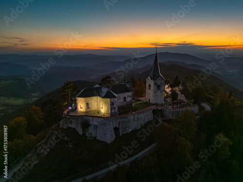 Evening view of the Church of the Birth of Mary atop Zasavska Sveta Gora, a historic pilgrimage site with Gothic and Baroque architecture.