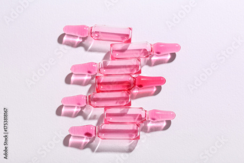 Pink glass ampoules with li...