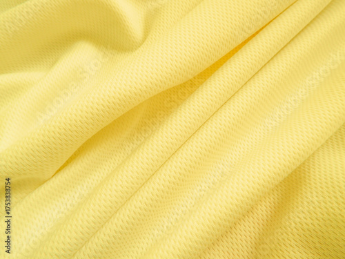 Yellow fabric background. Wavy cloth texture