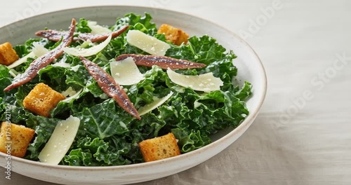 Fresh kale salad with croutons and parmesan shavings