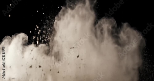 Dust cloud explosion in a dark studio background