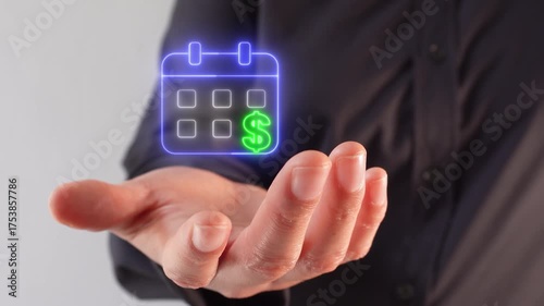 Organizing payments and income. Close-up of a woman's hand holding a virtual icon of a calendar with a money sign.