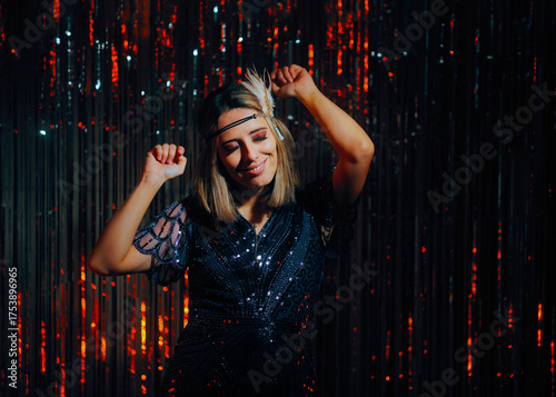 Cheerful Flapper Girl Dancing Having Fun at a Party. Lovely lady feeling good in a glamorous retro 20s inspired styling