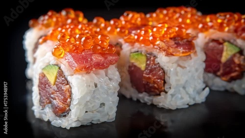 Delicious sushi rolls with fresh ingredients, including fish, avocado, and bright orange roe. White rice encases fillings