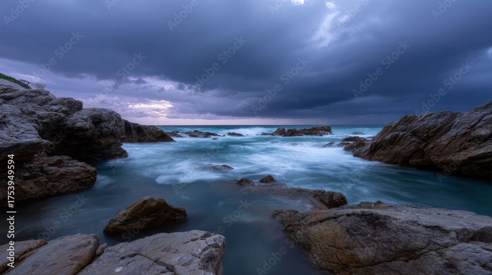 Fototapeta premium Dramatic coastal seascape with rocky shoreline and dark storm clouds
