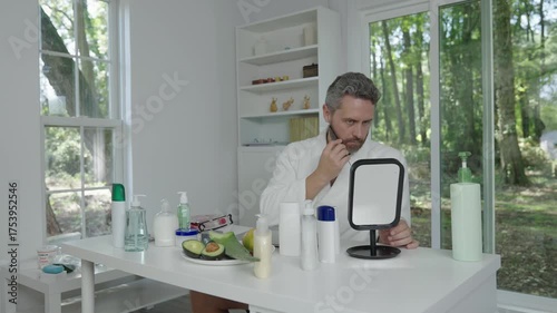 Haircare and styling. Bearded man personal beard hair care. Beard grooming using comb. Hispanic man combing beard. Mature man styling beard with comb. Beauty morning routine for man, 4k footage