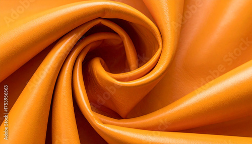 Vibrant Swirl: A close-up shot captures the dynamic spiral of luxurious, orange fabric, emphasizing its smooth texture and radiating warmth.