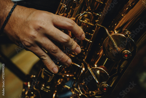 Close-up of male musician playing saxophone during jazz rehearsal