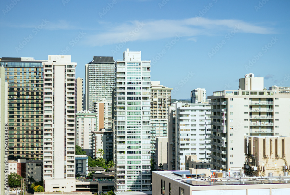 Fototapeta premium Modern residential high-rises in a sunny city under blue sky