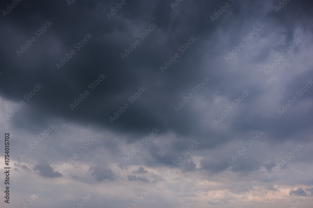 Fototapeta premium Dark sky with stormy clouds. Dramatic sky rain,Dark clouds before a thunder-storm,clouds before rain