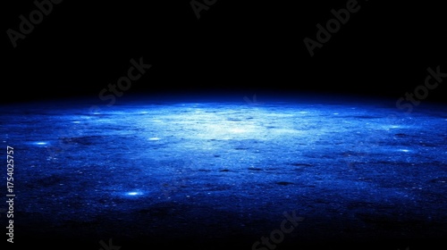 A mysterious dark surface illuminated by soft blue light with glowing spots and reflections creates a serene and abstrac