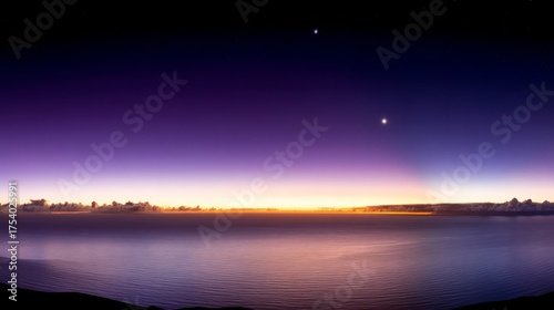 A serene twilight scene over water features hues of blue blending into orange near the horizon,