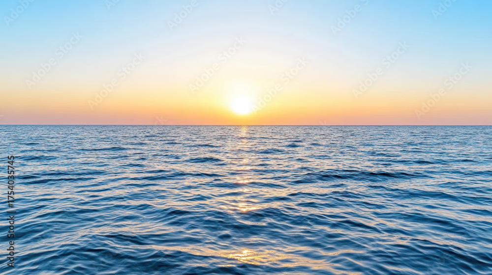 Obraz premium Calm sea with gentle waves reflecting sunset colors, creating serene atmosphere